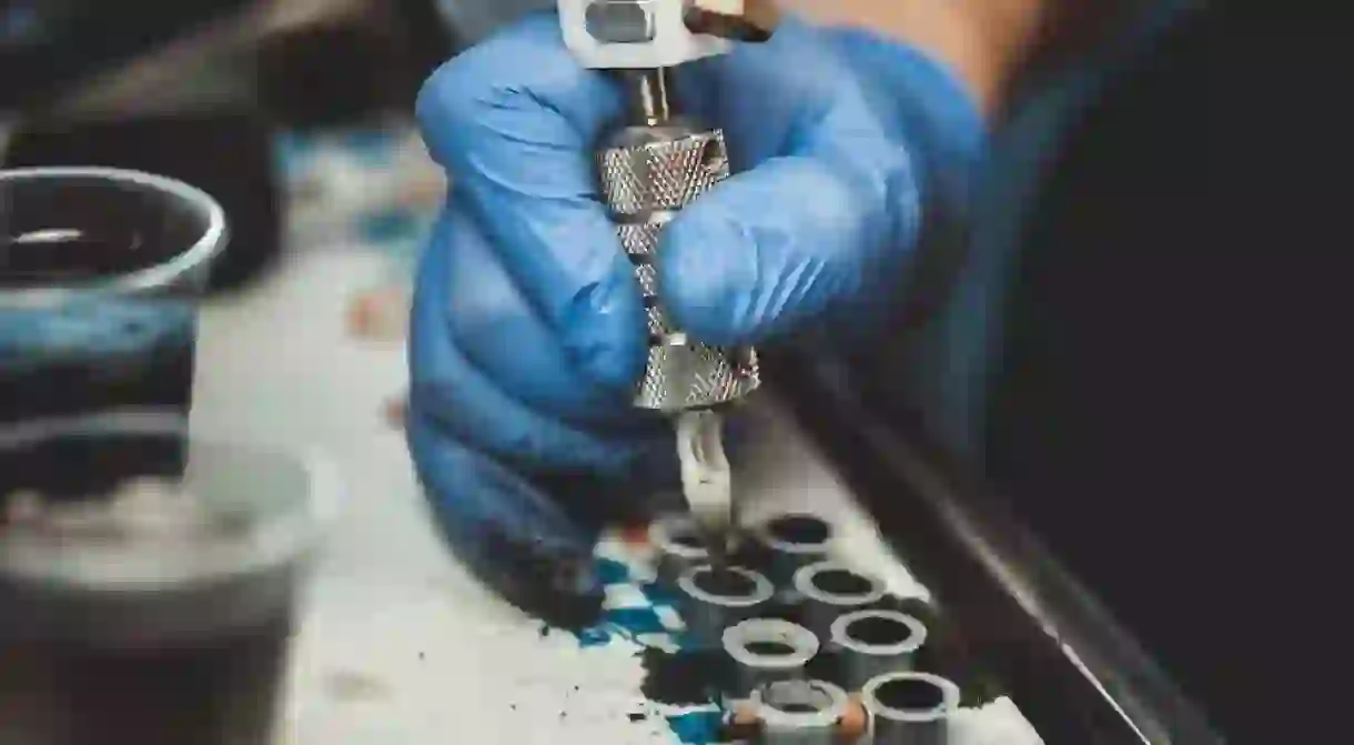 Tattoo artist prepares his ink