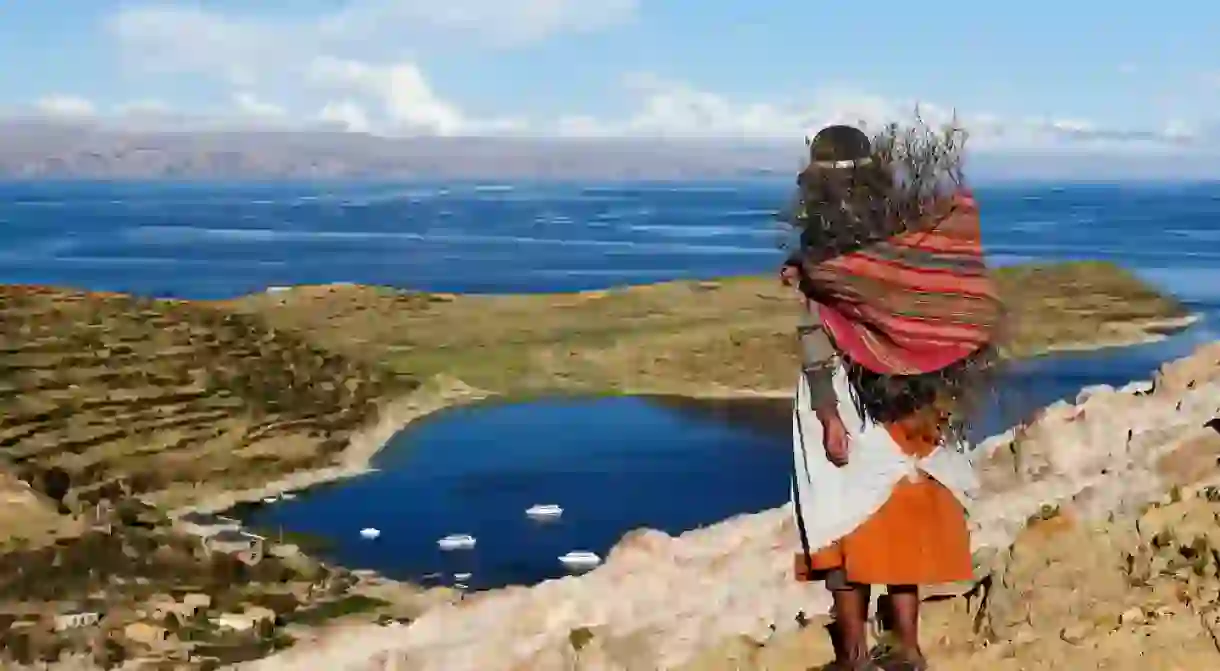 A native woman looks out over Lake Titicaca from Bolivias Isla del Sol