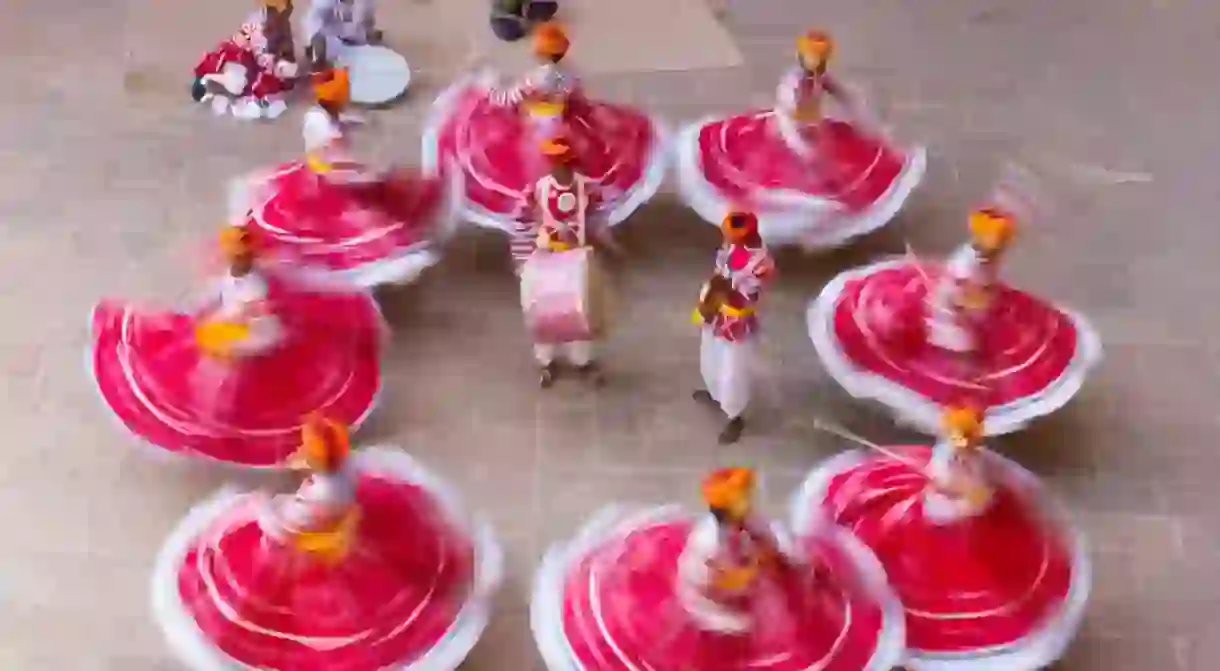 Dancers in Rajasthan in red skirts and yellow turbans