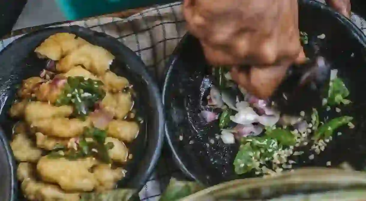 Grinding chillies in West Java, Indonesia