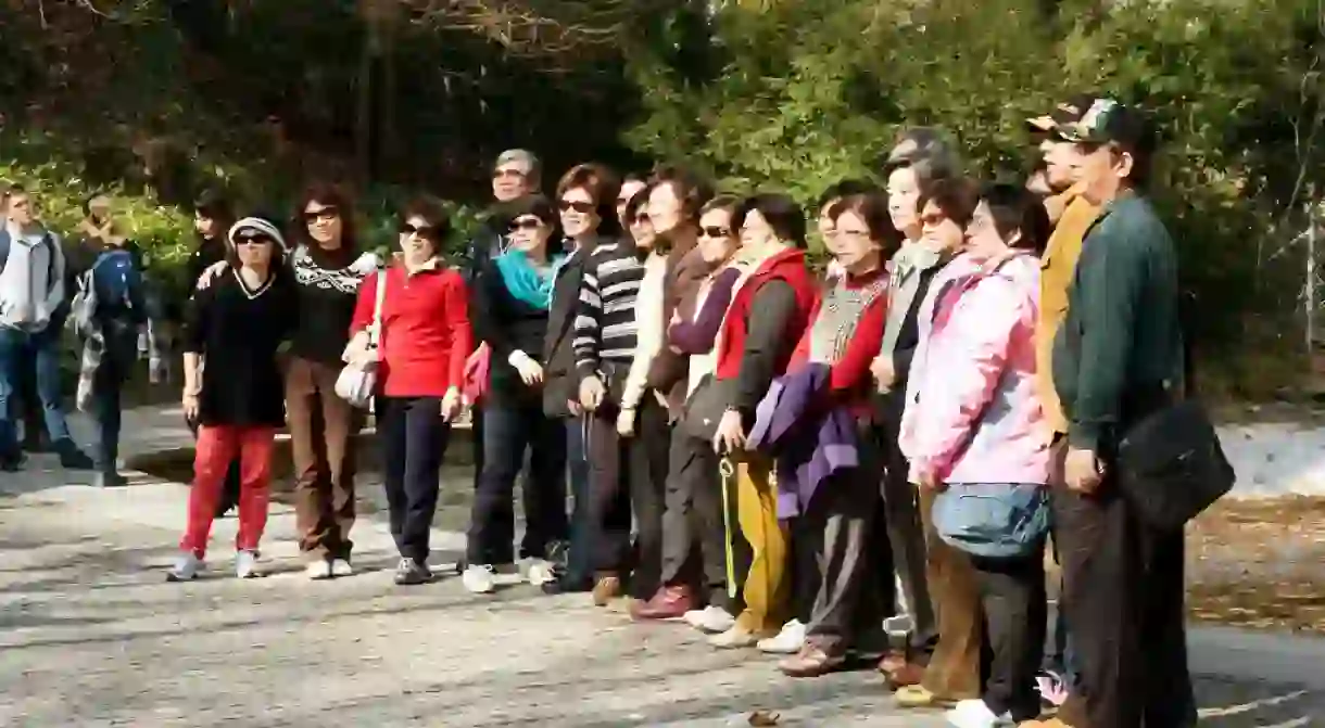 Chinese tourists having photo taken