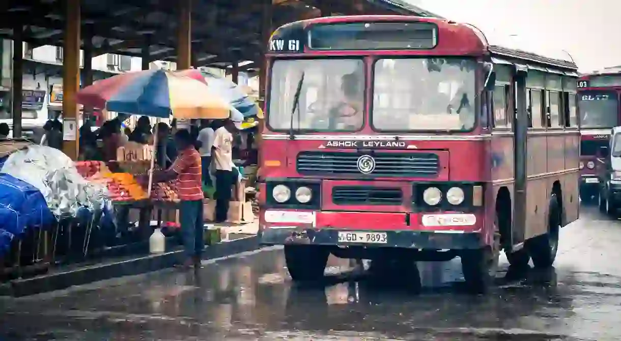 A red bus in the rain in Colombo