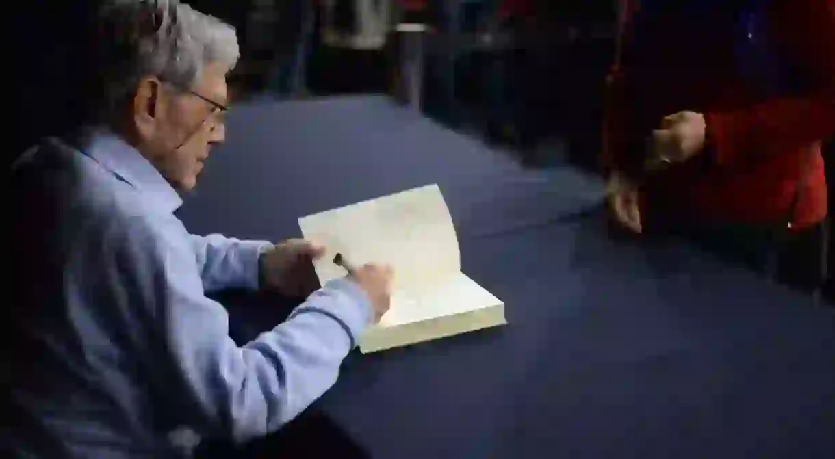 Amos Oz signing a book, 2017