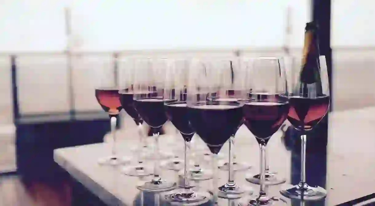 Wine Glass With Red Liquid on Black Table