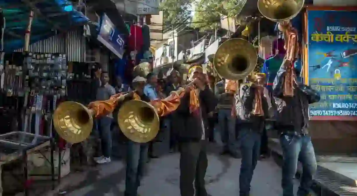 Musicians blowing large trumpets during the annual Dusshera festival at Kullu