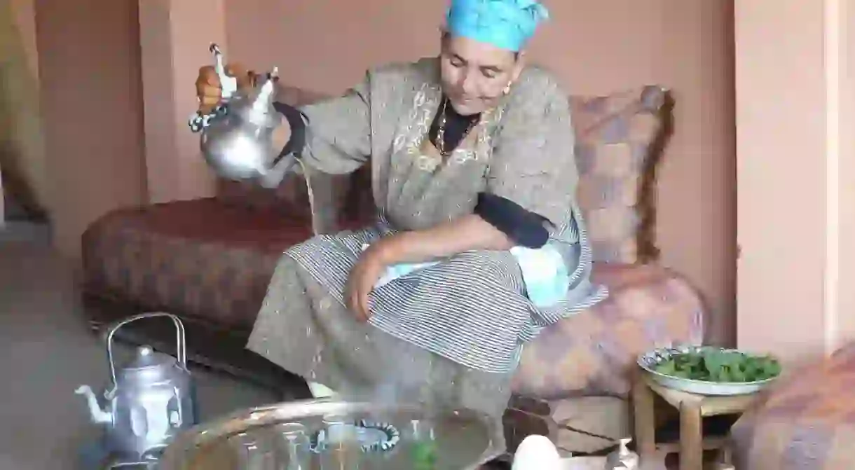 A Moroccan lady preparing mint tea