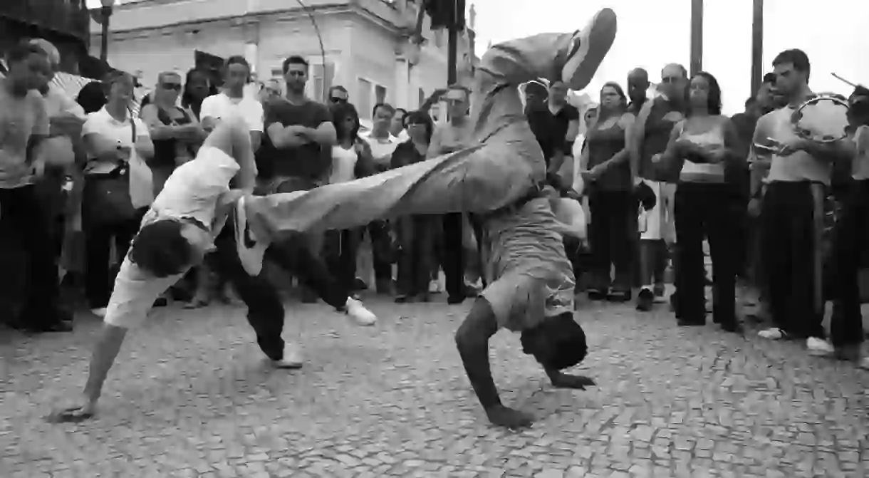 Capoeiristas use acrobatic moves to evade attacks