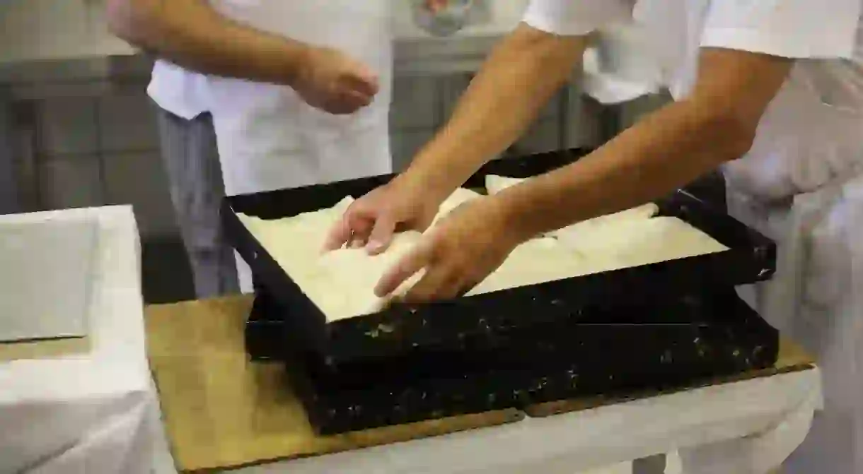 Bakers add the final touches before the bougatsa goes into the oven