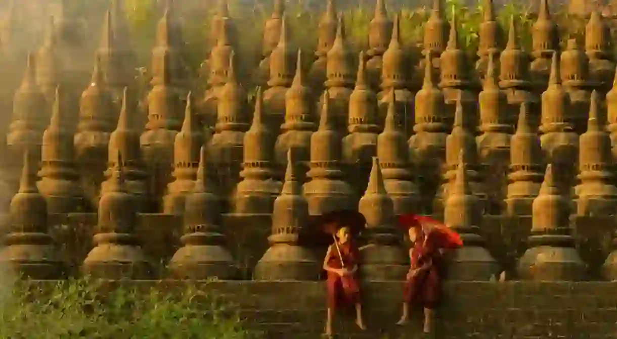 Novice monks hold traditional umbrellas at Ratanabon Paya in Mrauk U, Myanmar