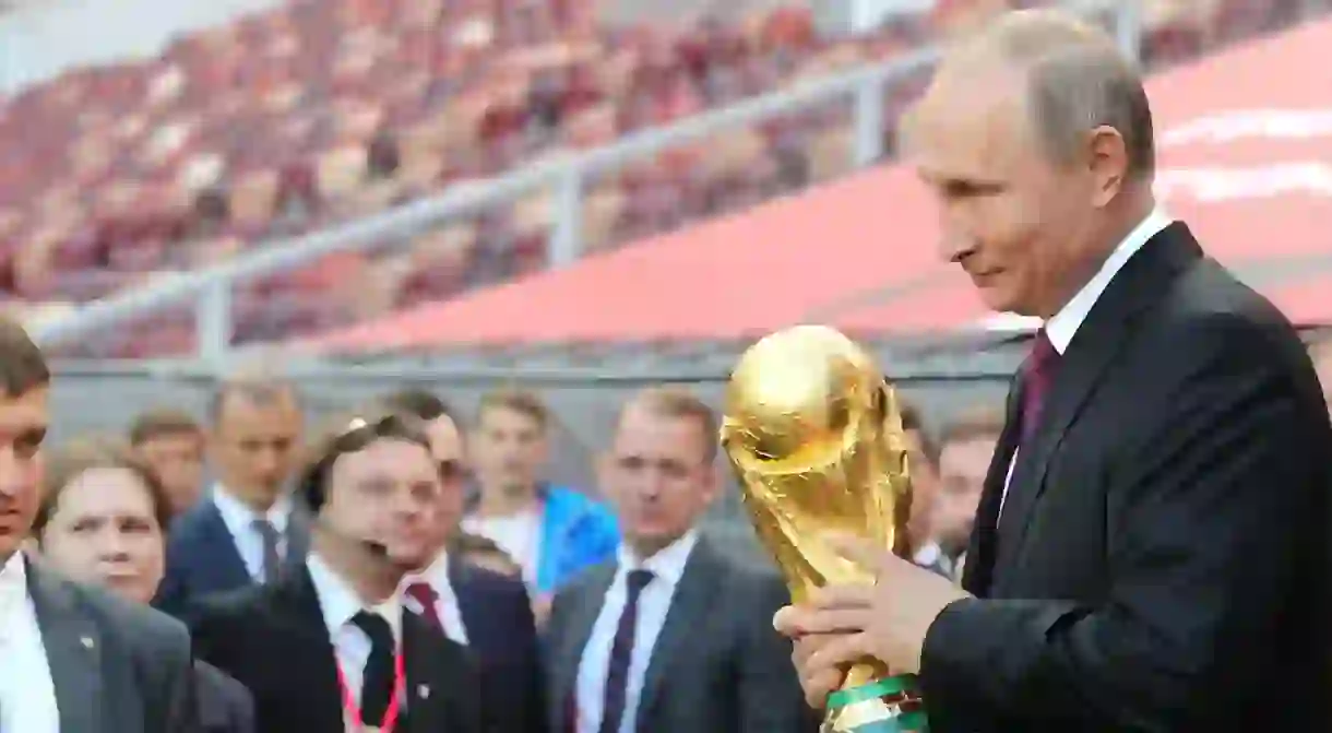 Russia president Vladimir Putin holds the World Cup Trophy