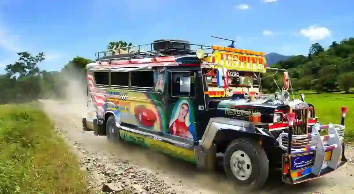 Jeepney with race car and Virgin Mary image