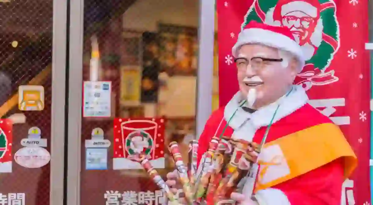 A festive Colonel Sanders greets customers at KFC in Japan