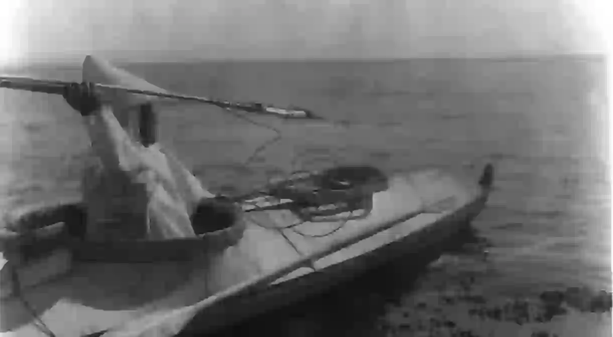 An Eskimo ready to throw a spear in the waters of Alaska, 1927