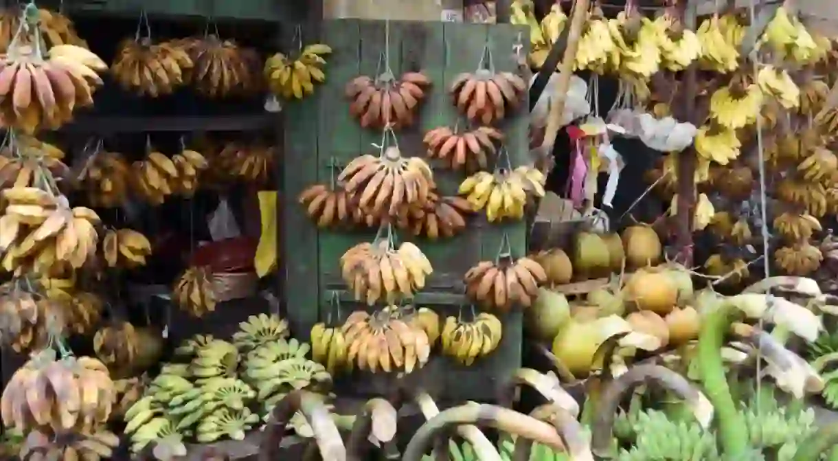 A variety of bananas hang from a banana shop on 17th Street in Yangon, Myanmar