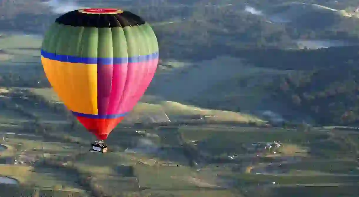 Maiden Voyage of Global Balloonings multi coloured balloon. Pilot, Brian Garth. Global Ballooning in Victorias Yarra Valley.