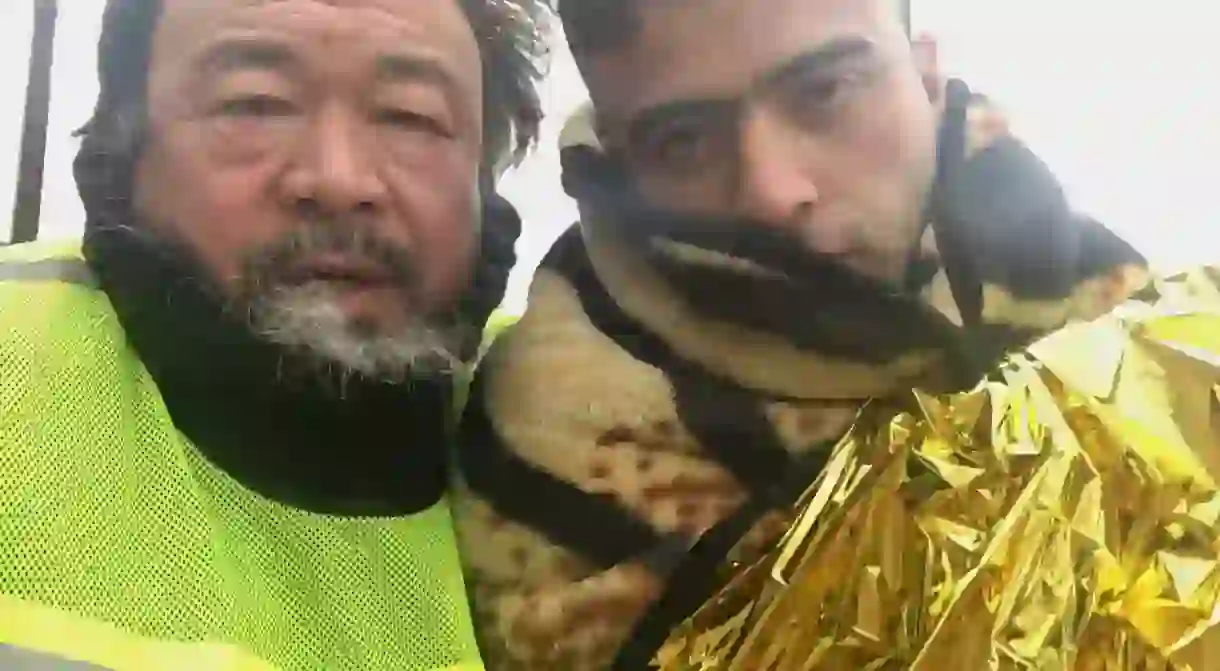 Still from Human Flow of Ai Weiwei with a migrant in Greece