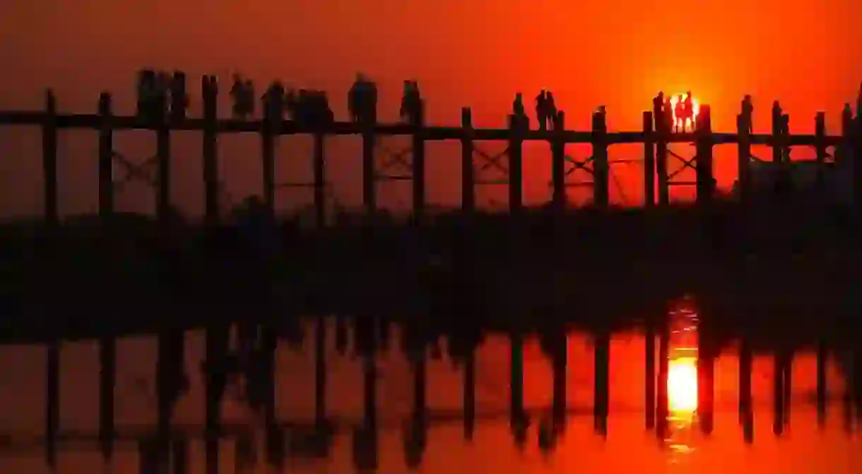 The sun sets vibrantly at U Bein Bridge near Amarapura, Myanmar