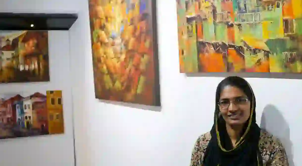 Sara Hussains paintings hang on display in an art Cafe in Kochi