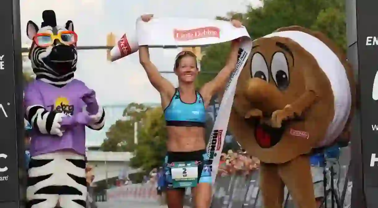 Liz Lyles holding the banner at IRONMAN Chattanooga