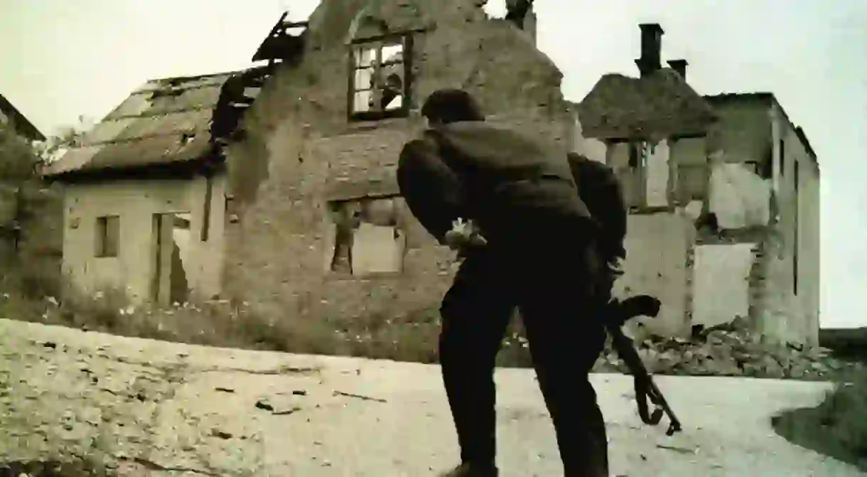 A Bosnian army fighter runs through a gauntlet of bullets during a battle between Bosnian Muslim and Bosnian Serb forces