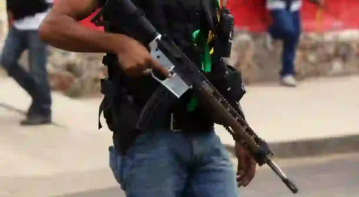 A vigilante holding a semi-automatic rifle