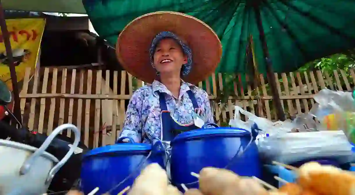 A woman sells snacks in Pai, Thailand