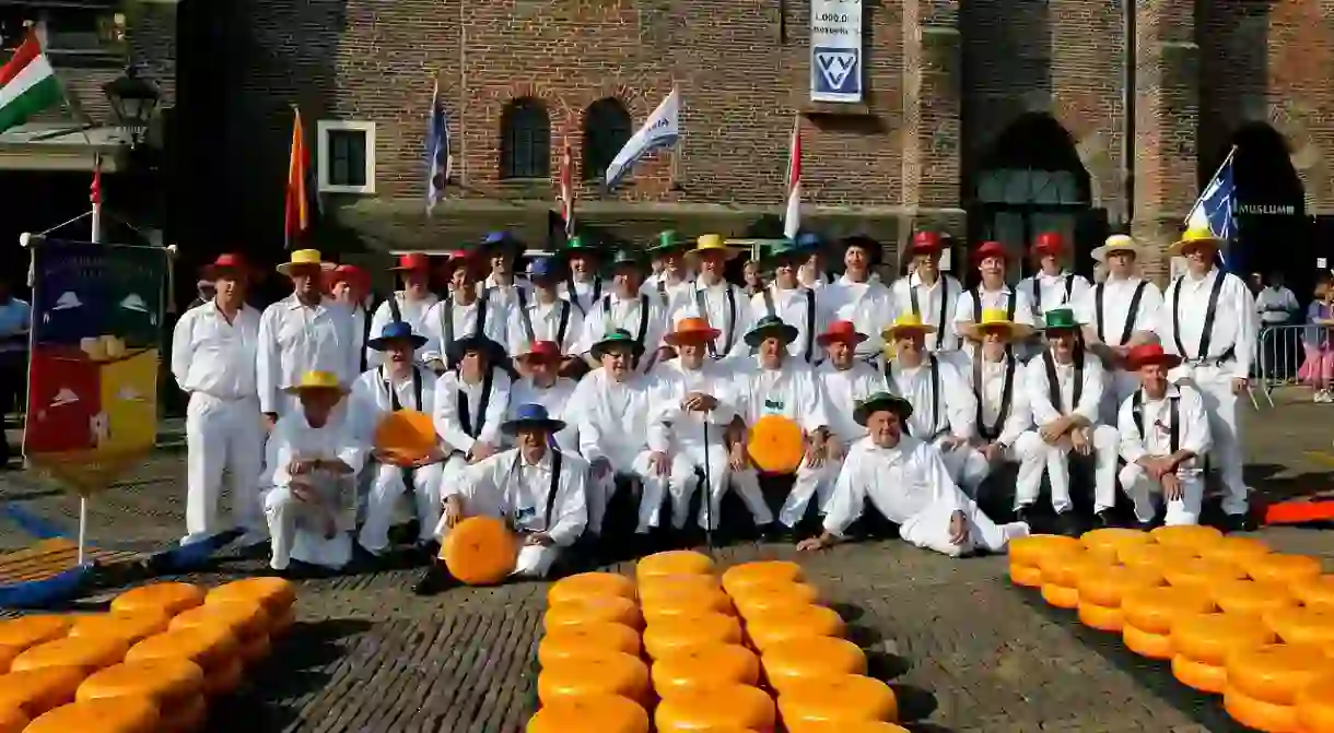 Cheese guild members dressed in traditional clothing at the market