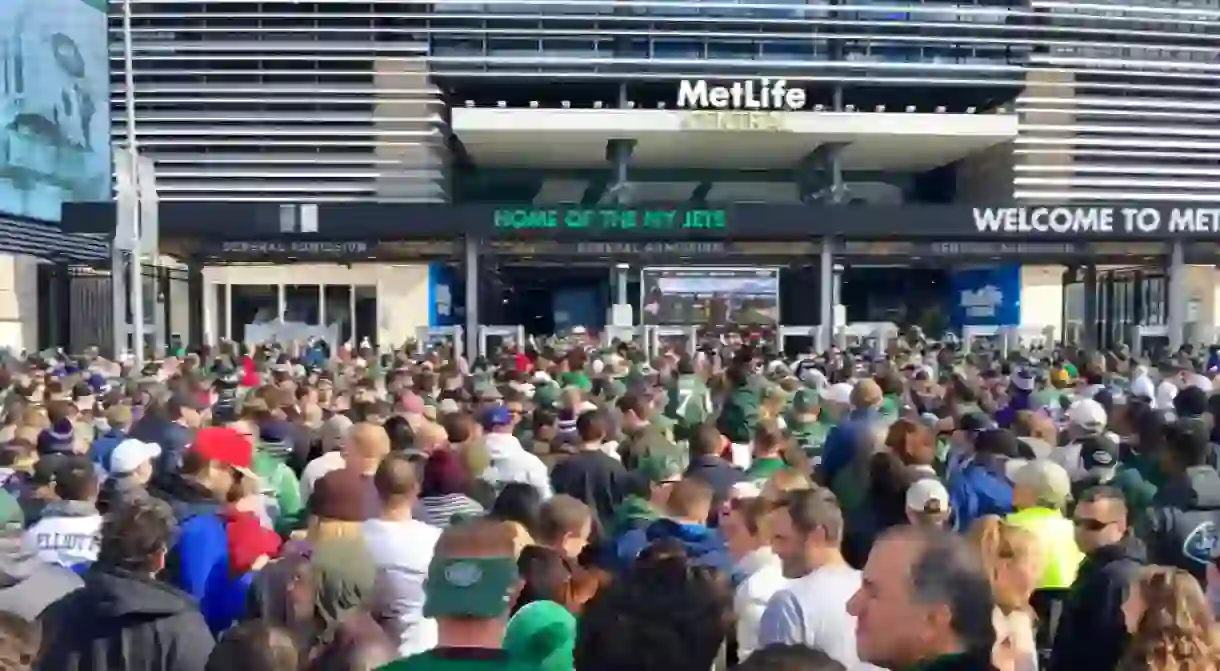 New York Jets fans wait in line to enter MetLife Stadium