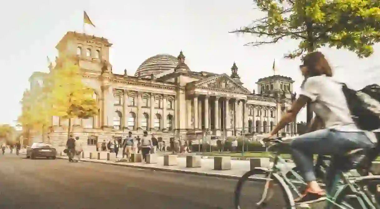 Girl rides past Berlin Reichstag