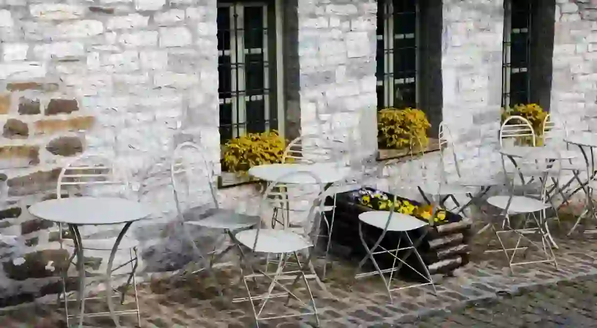 Tables in front of a traditional stone village of Papigo in Epirus, Greece