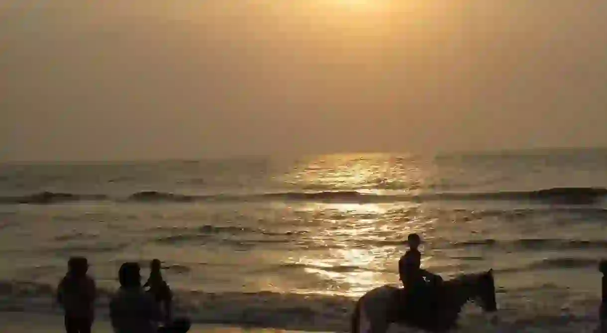 Visitors enjoying the sunrise at Besant Nagar Beach in Chennai