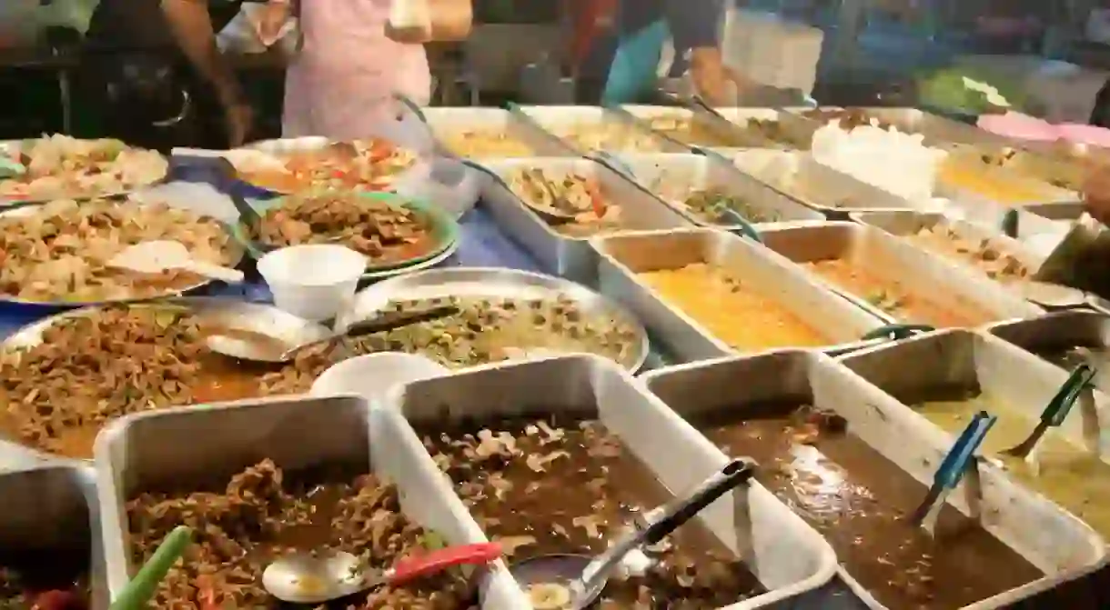 Tray upon tray of meals at a Thai food stand