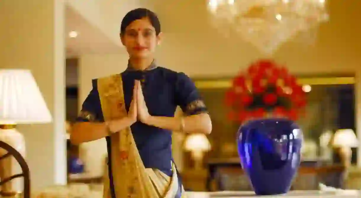 An employee at Oberoi Hotel, New Delhi doing Namaste