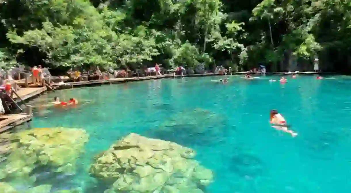 Tourists swimming in Kayangan Lake