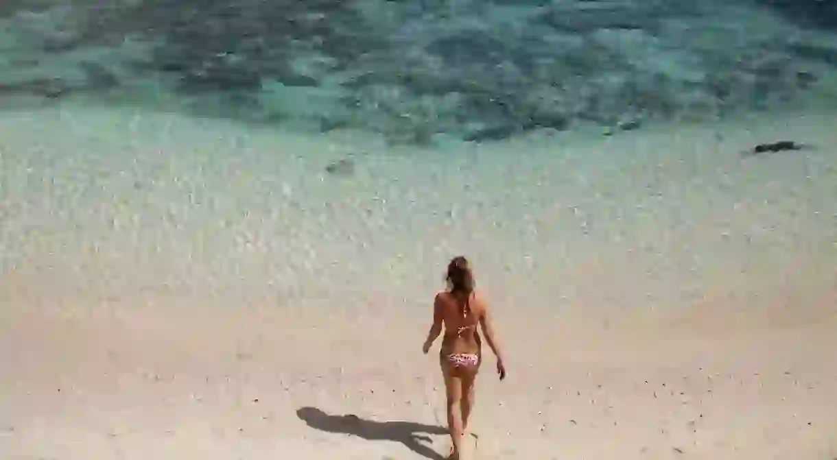 Woman walking on the beach in El Nido, Palawan