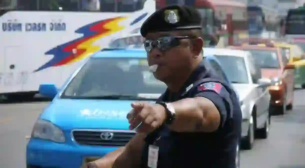 A Thai traffic policeman wearing sunglasses