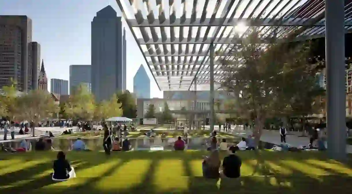 Visitors lounging on the lawn of the AT&T Performing Arts Center on a nice day