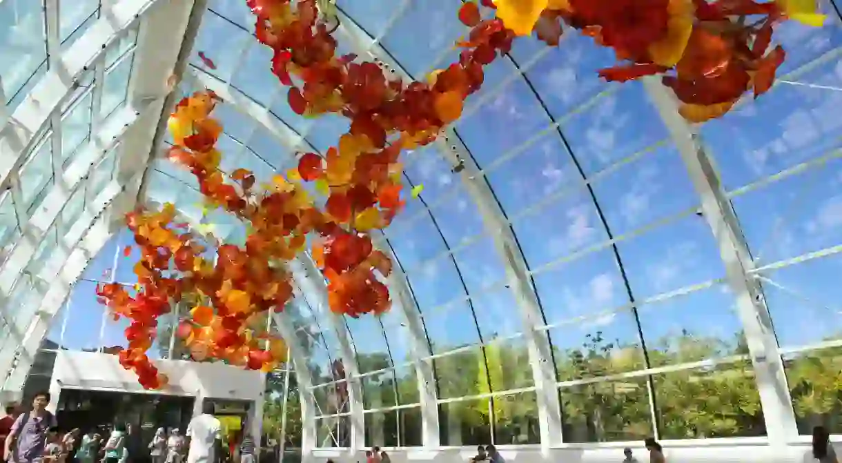 Visitors enjoy the Glasshouse at the Chihuly Garden and Glass