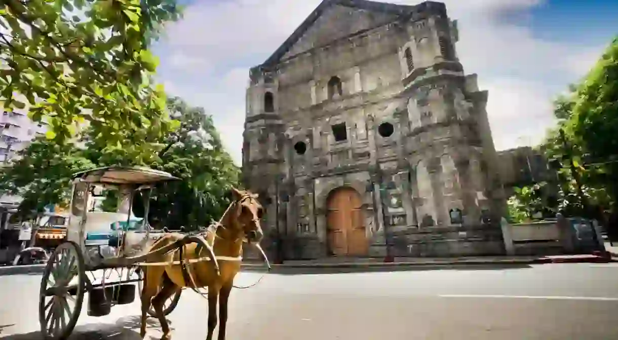 Horse-drawn calash in front of Malate Church in Manila, Philippines