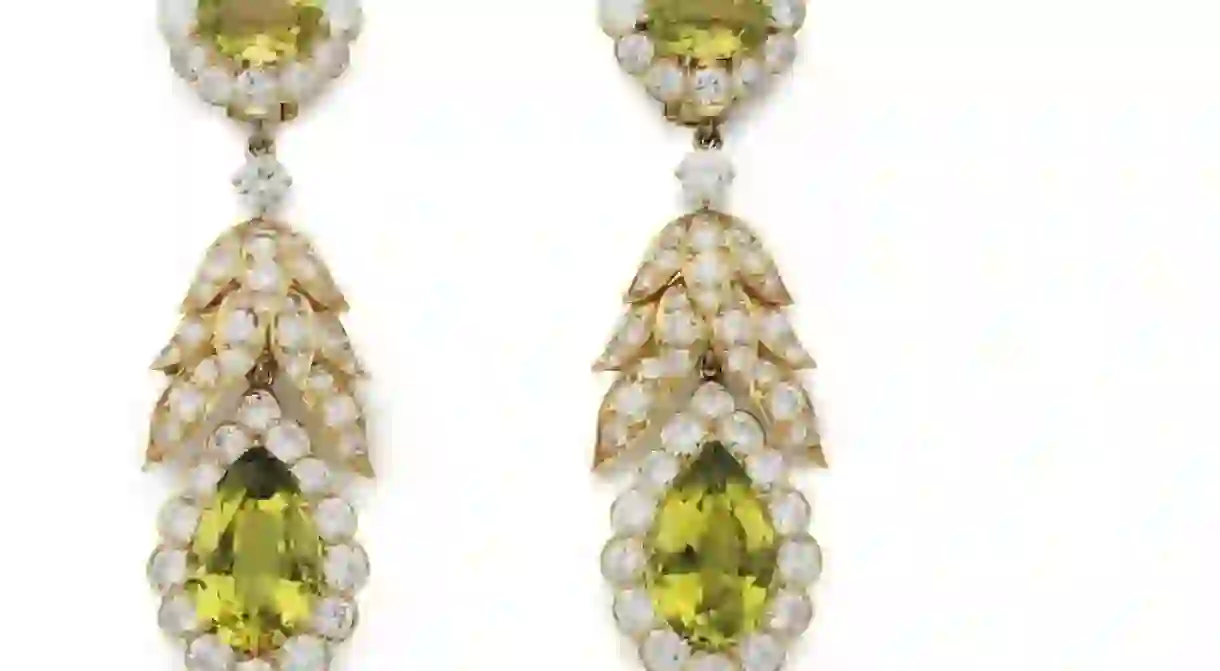 A suite of peridot and diamond jewelry by Van Cleef & Arpels, comprising a necklace, bracelet, ear pendants, and a ring. Estimate: $80,000–$120,000