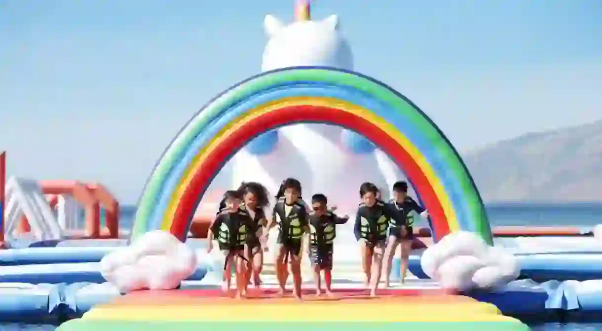 Kids running across rainbow walk at Unicorn Island