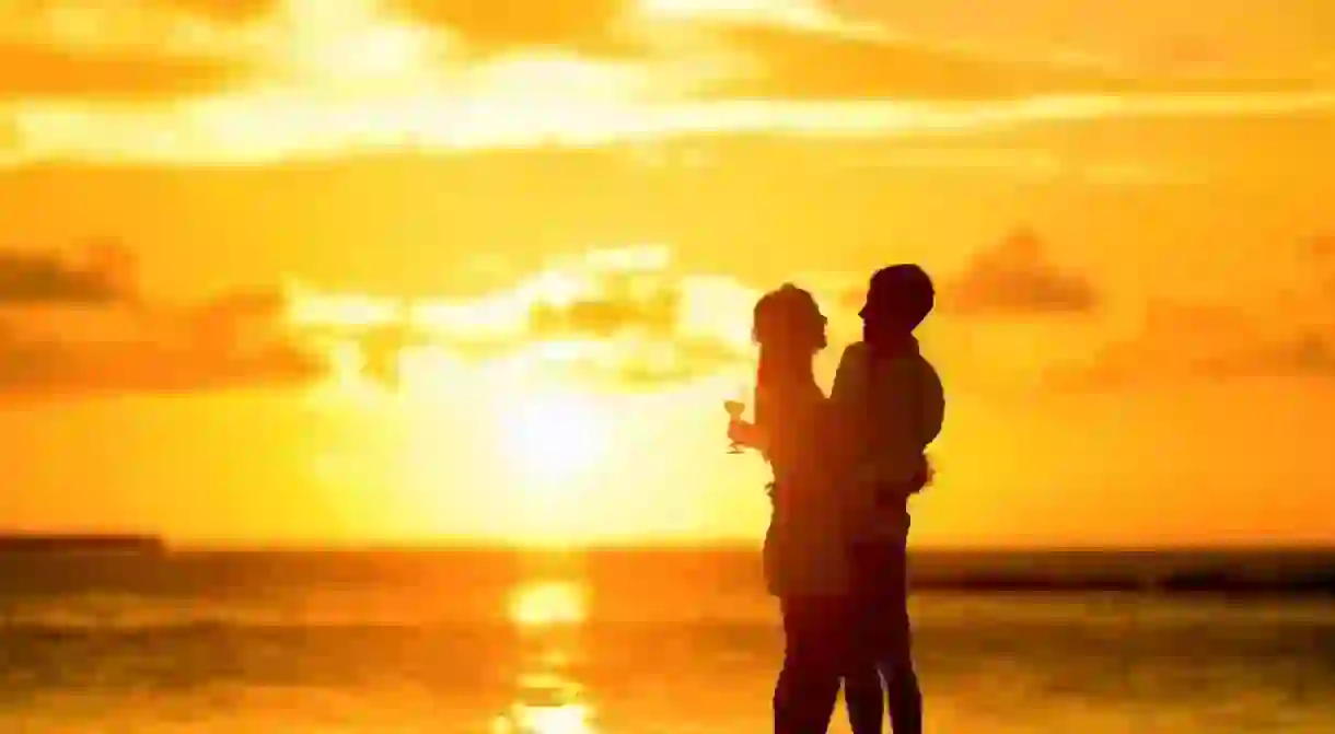 Couple on beach at sunset.