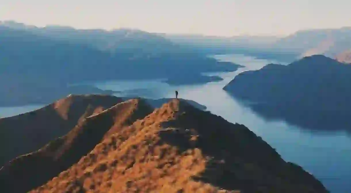 A visitor exploring Roys Peak, New Zealand