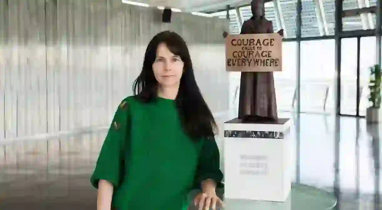 Gillian Wearing in front of a maquette of her Millicent Fawcett sculpture