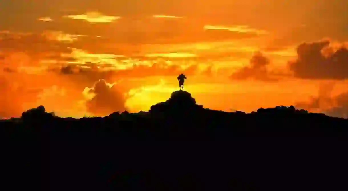 Maasai man burning sky