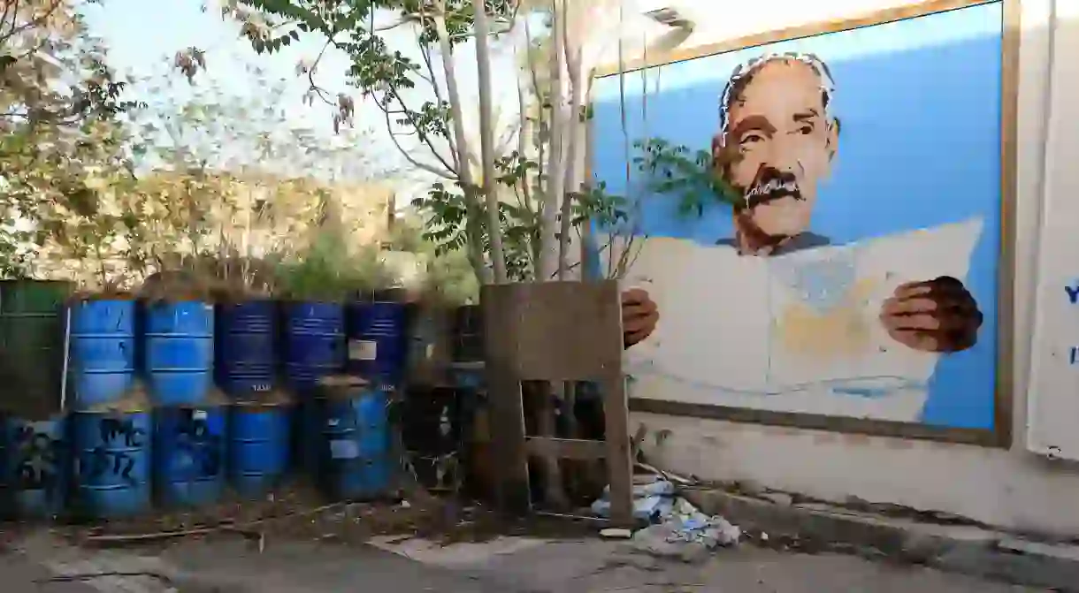 A portrait of a grandfather decorates the wall of a quiet street in Nicosia