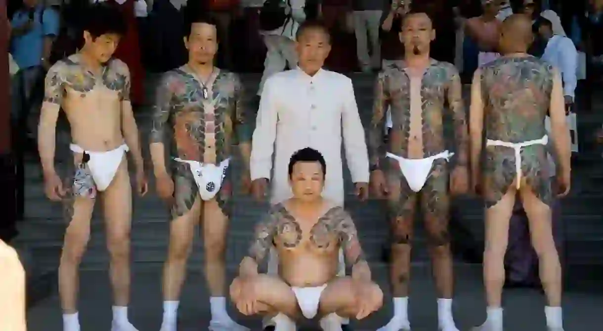 Men display their Yakuza-style tattoos at a festival in Asakusa, Tokyo