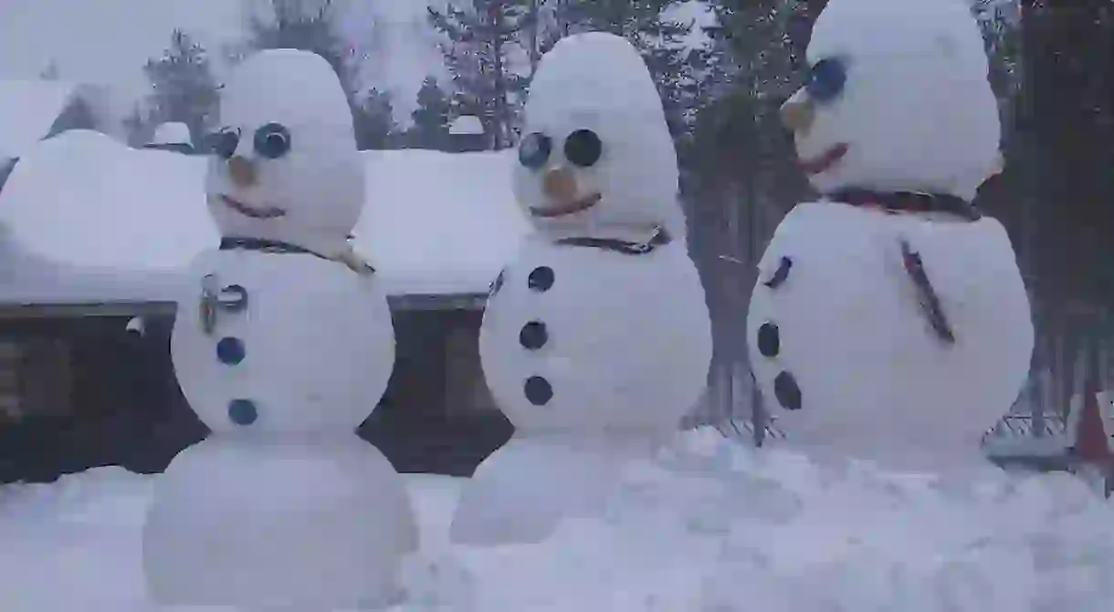 Snowmen sculptors greet visitors to the Santa Claus Village in Rovaniemi.