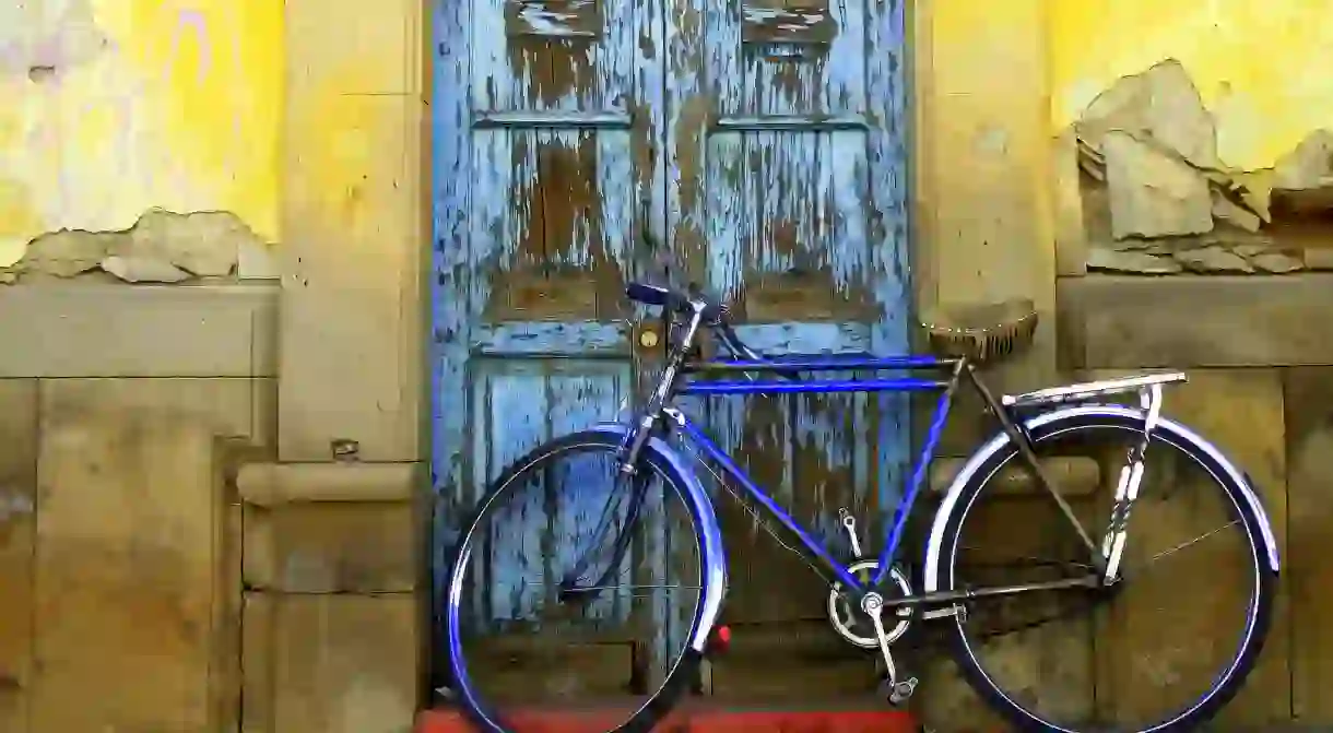 A bike propped against an old doorway in Durango