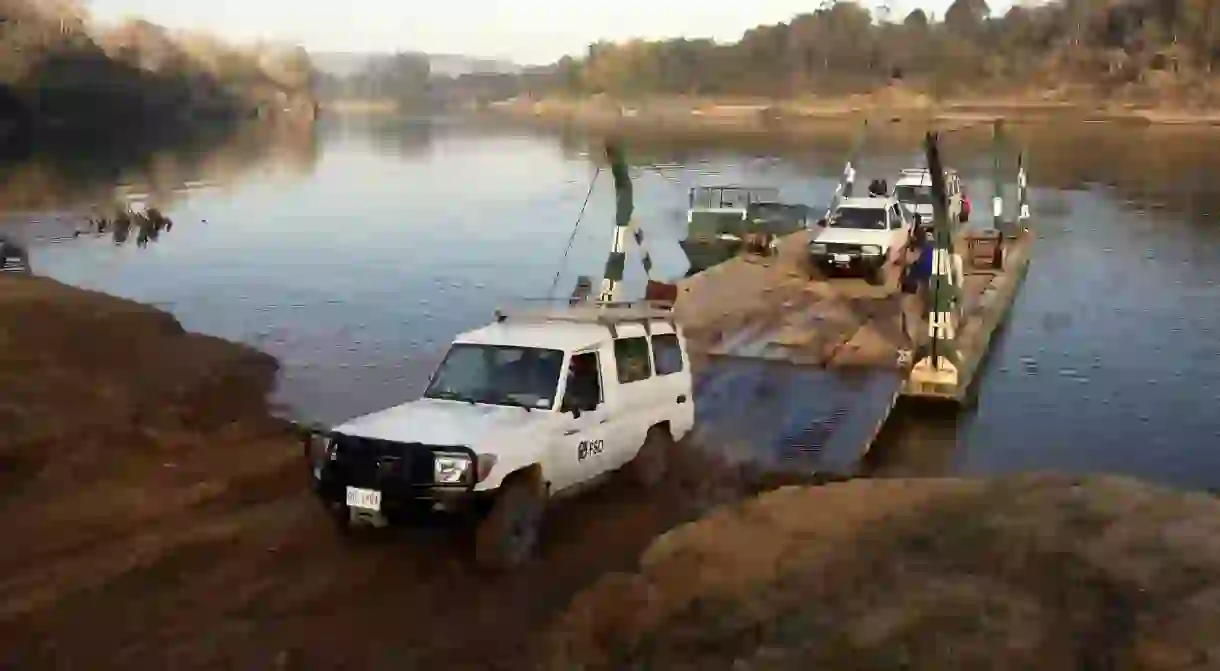 Vehicles cross the Sekong River